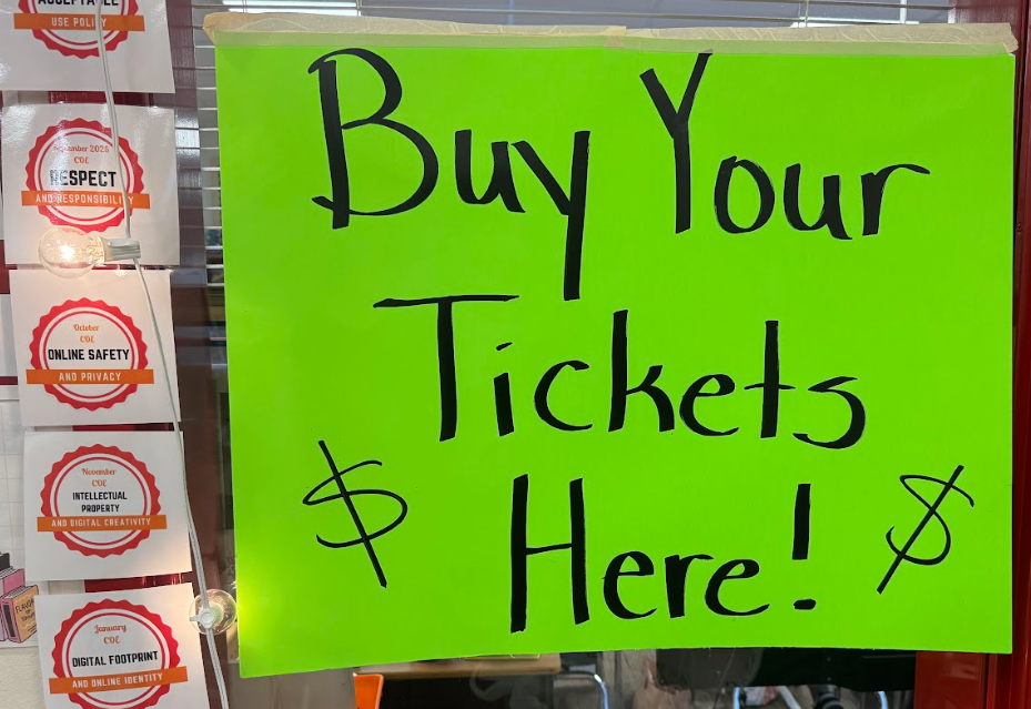 Green sign that says "Buy our Tickets Here!" with two dollar signs