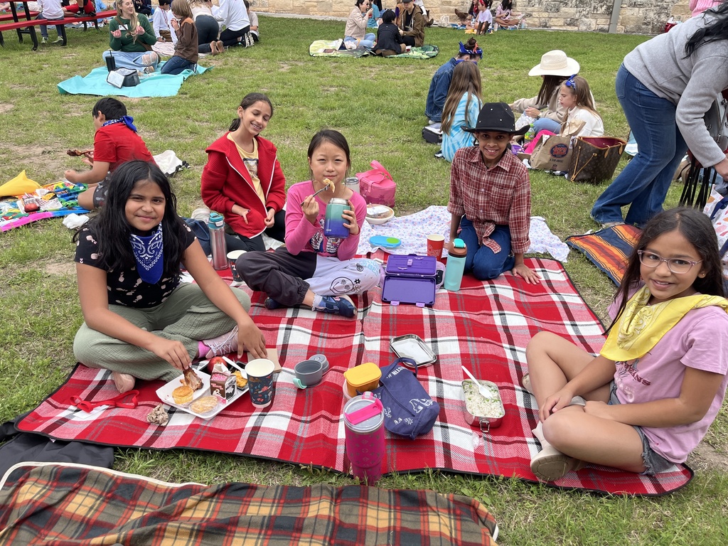Students eating a picnic lunch. 