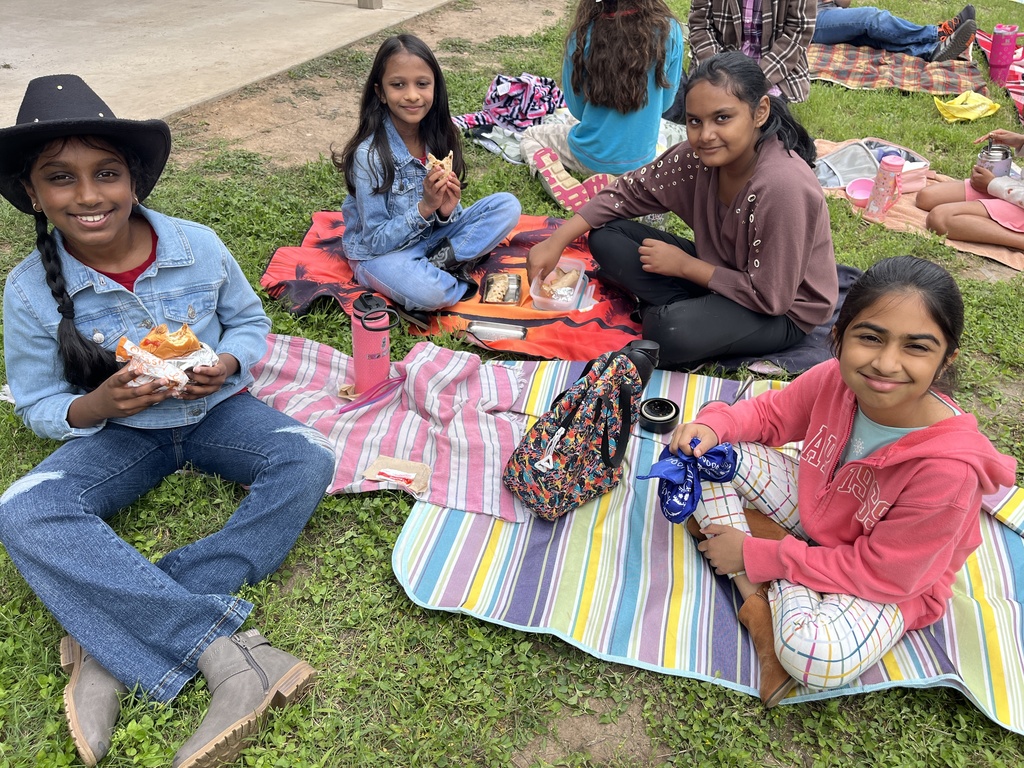 Students eating a picnic lunch. 