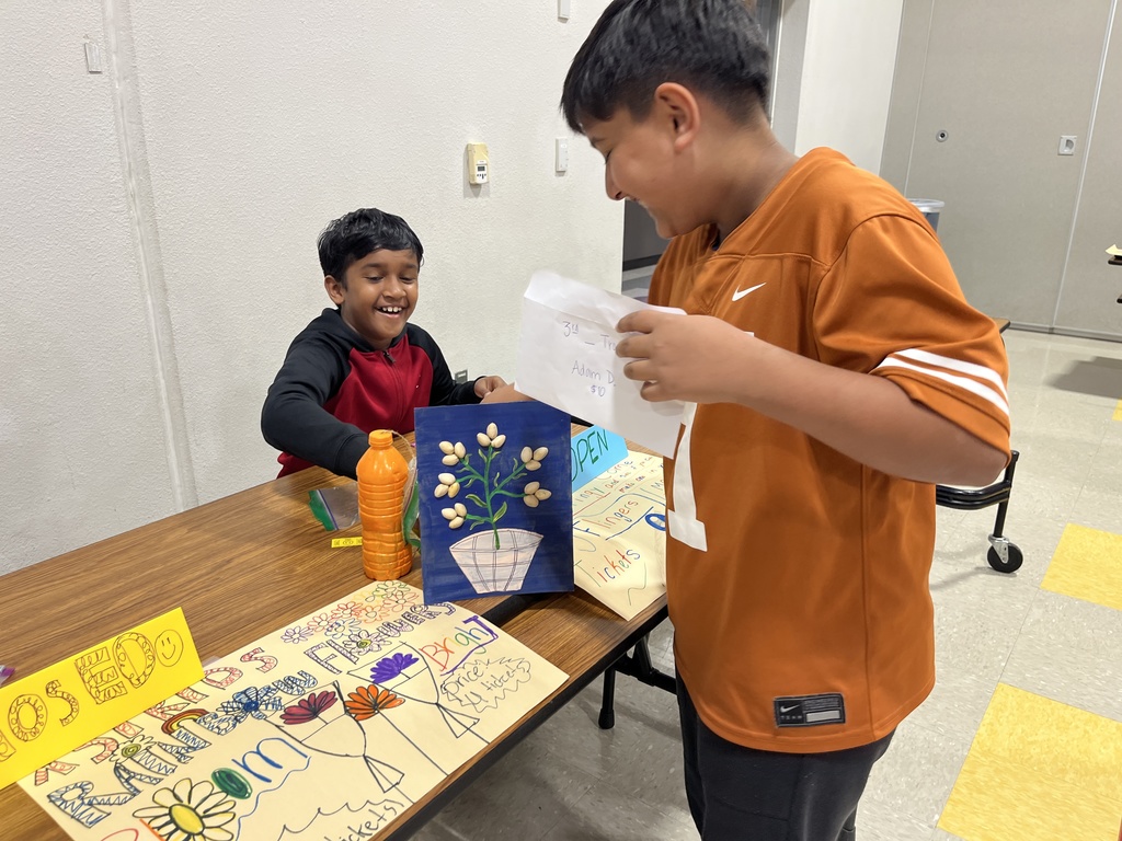 Two boys exchange tickets for a product. 