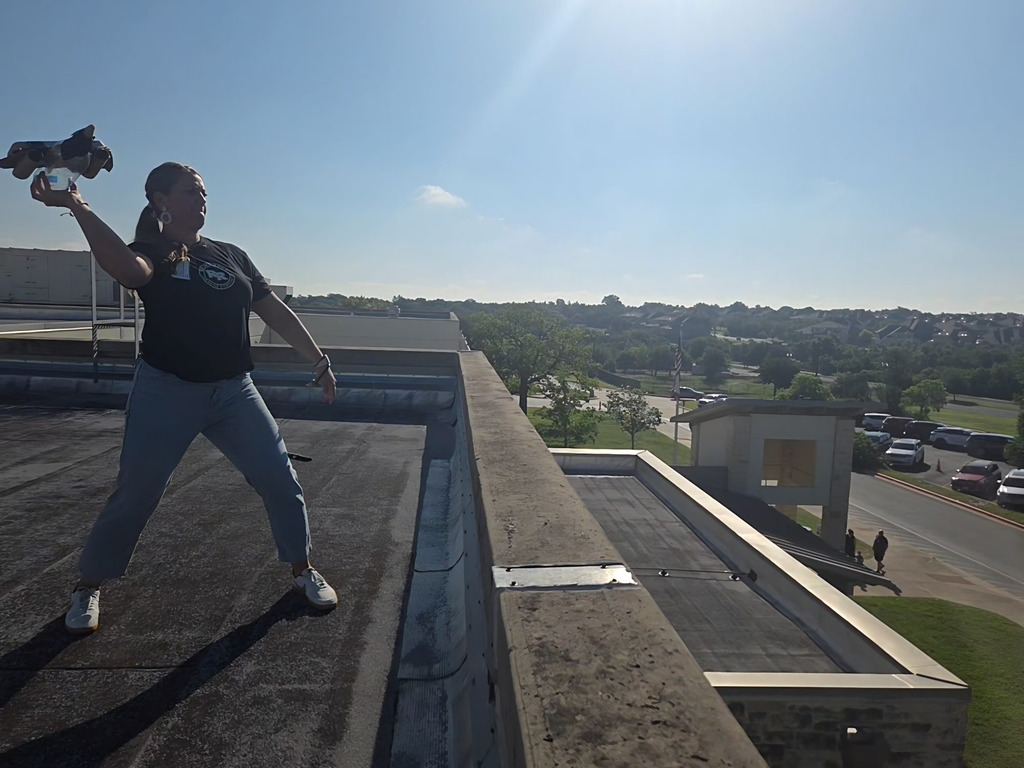 Ms. Elarms throwing a plane.