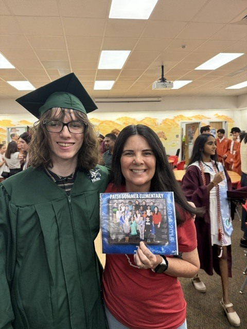 Mrs. Troccoli posing with a former student. 