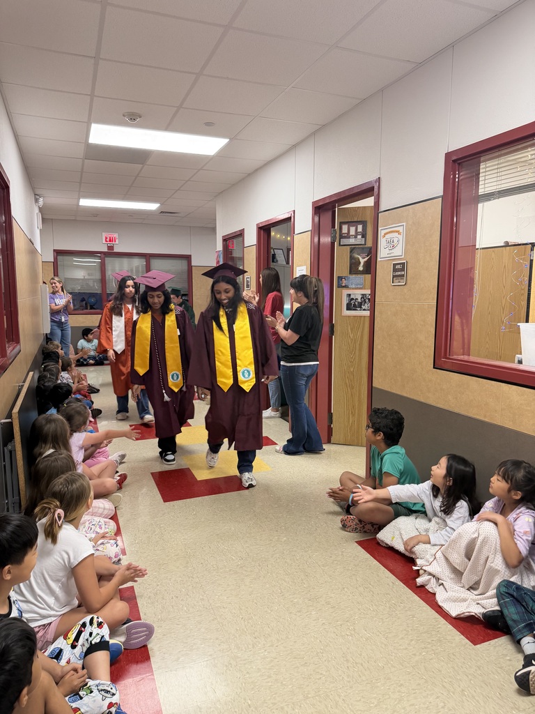 Seniors high-fiving the younger students. 
