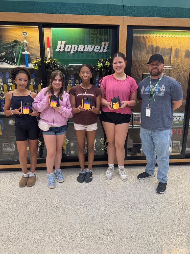 Picture of four student holding their trophy and their teacher Mr. Murphy.