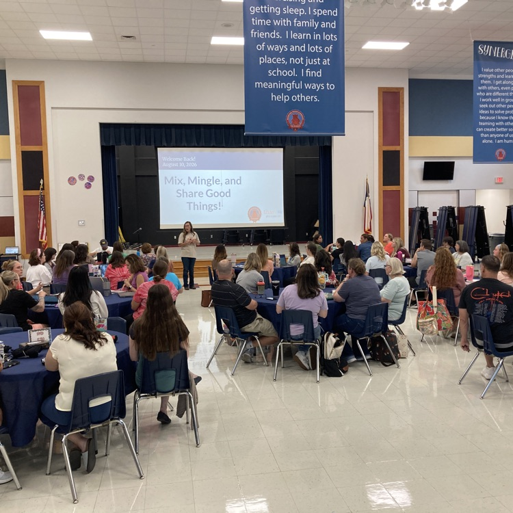 Blackland Prairie teachers gathered at round tables in the cafeteria for a Welcome Back presentation with a screen displaying Mix, Mingle, and Share Good Things
