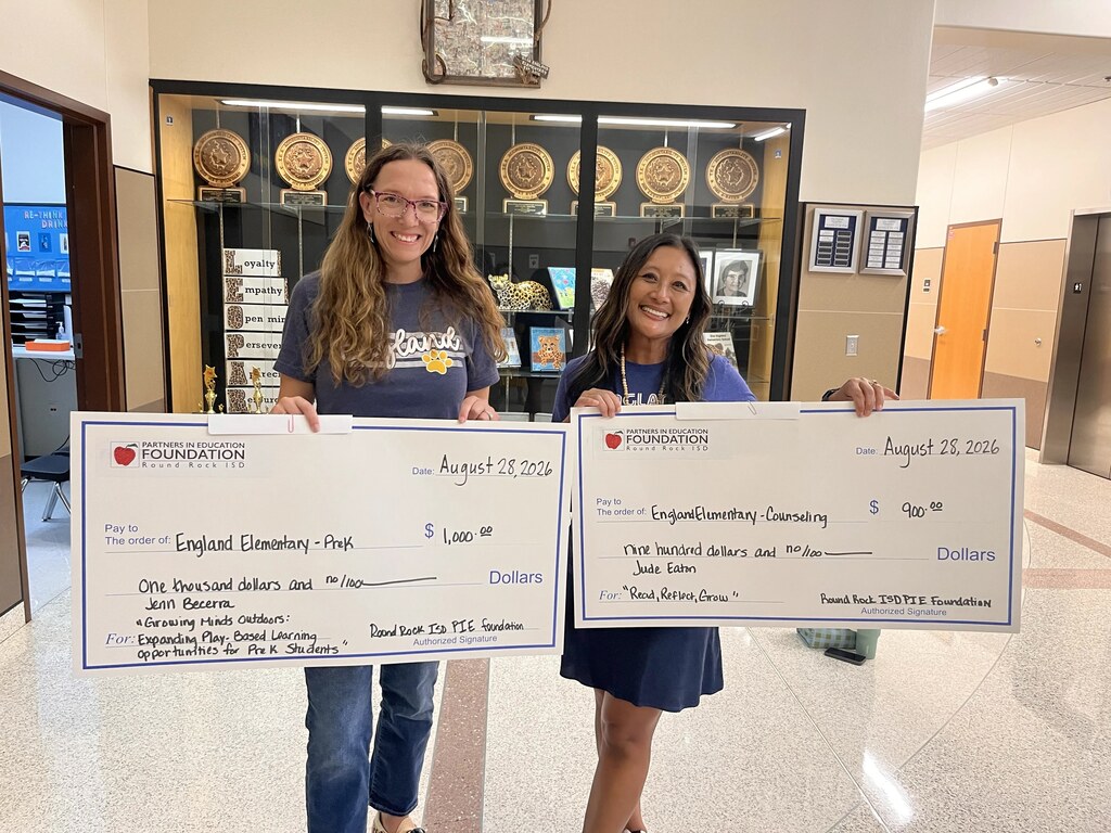Picture of staff member at Enlgand Elementary recieving PIE Grants.