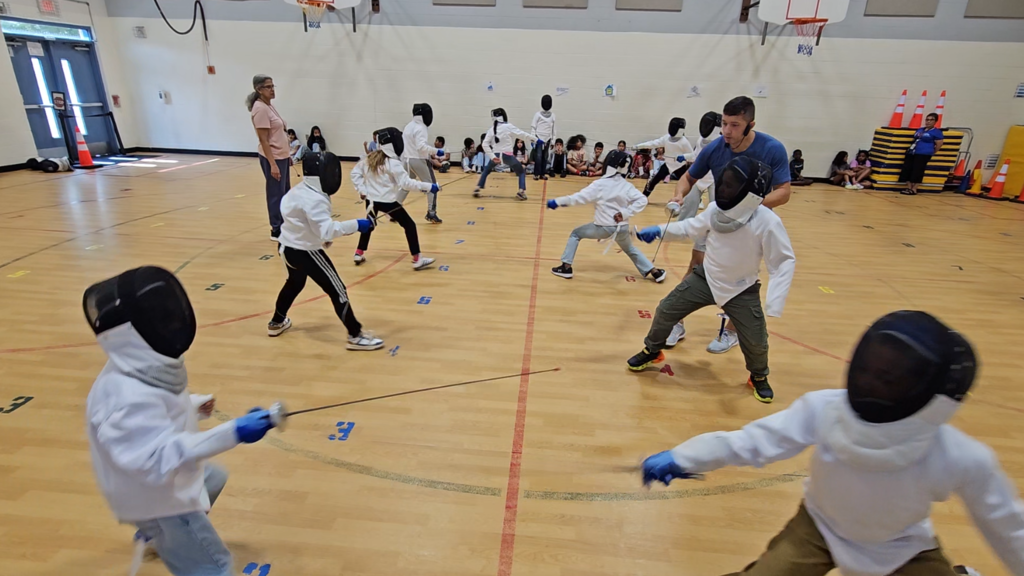 students in fencing gear