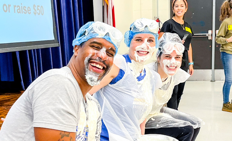 Jenny Strong with assistant principals getting pie'd by students