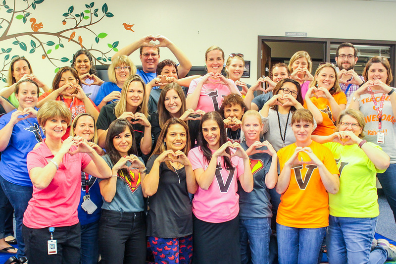 Cheryl Hester with staff holding heart hands