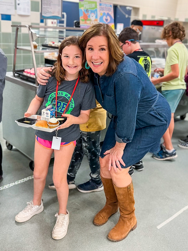 Vicki Crain with a student in a lunch line