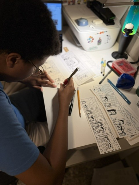 Elijah drawing comics