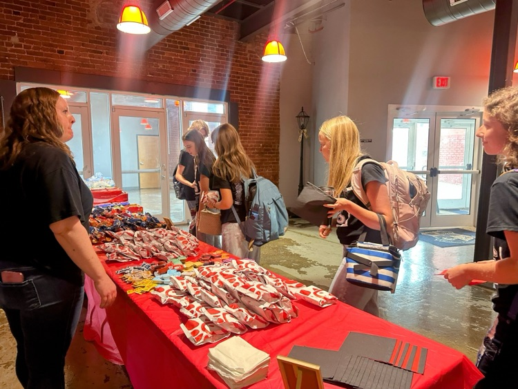 students taking Chick-fil-A sandwiches from a table