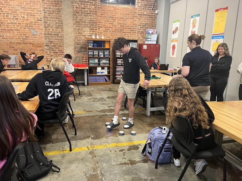 A male student steps on a light to test his mobility. 