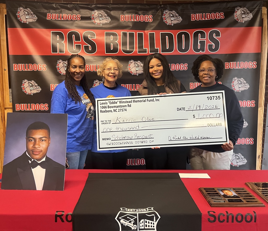 Karrie Obie receiving a giant scholarship check for $1,000 from the Lewis "Eddie" Winstead Memorial Fund Scholarship.