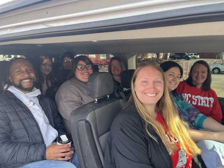 A group of teachers and students in a 12 passenger van