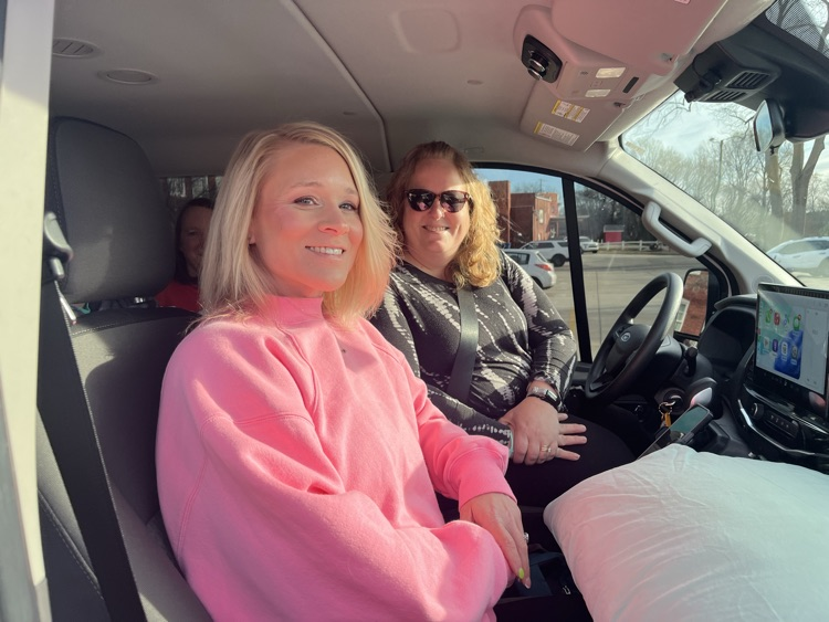two female teachers in the front seats of a 12 passenger van