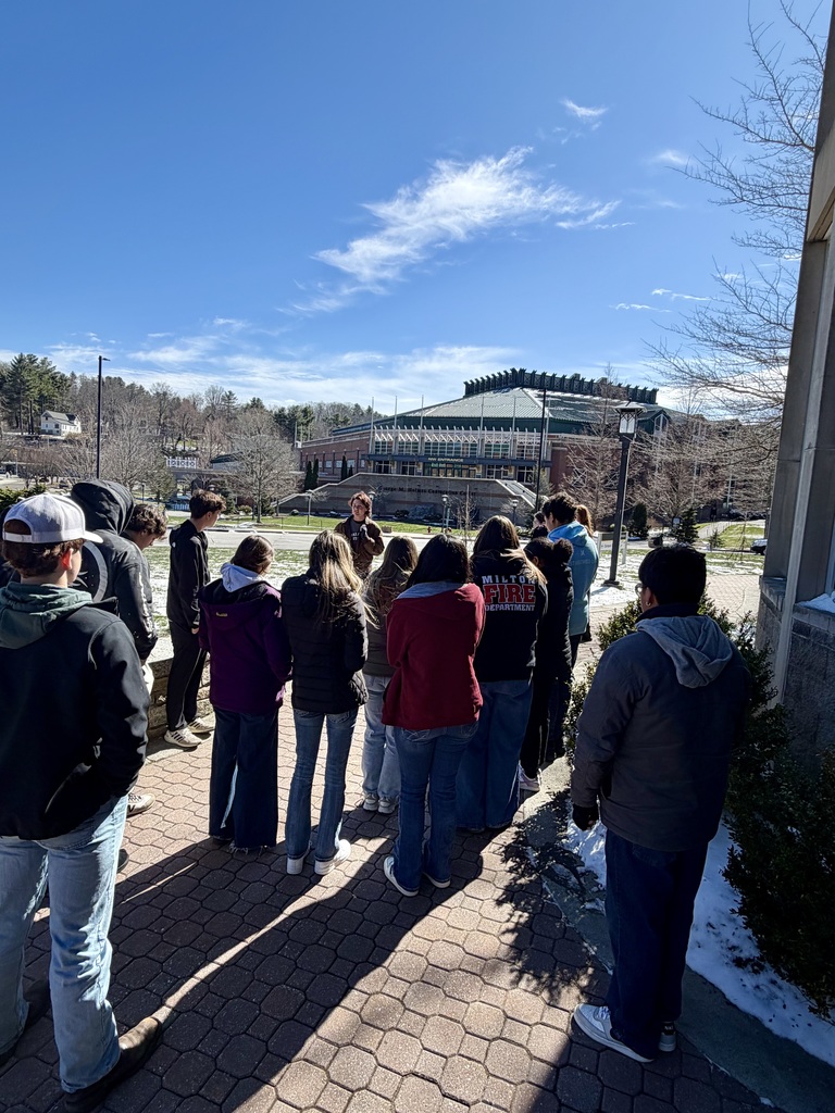 A group of students listening to a tour guide on Appalachian State University's campus.