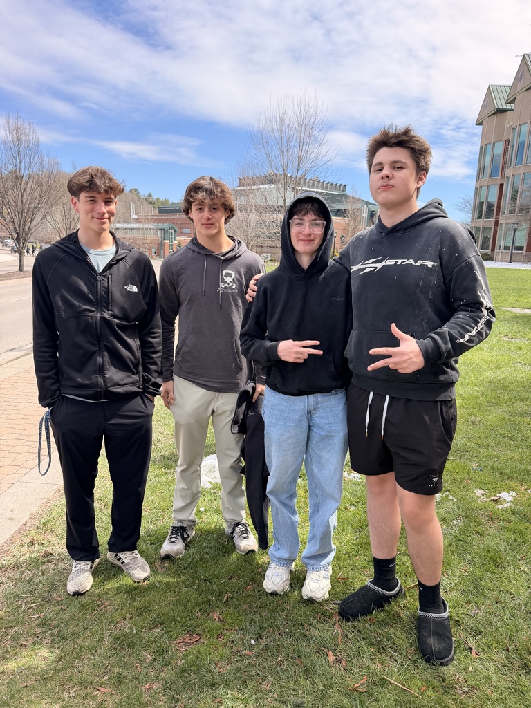 4 male high school students smiling outside
