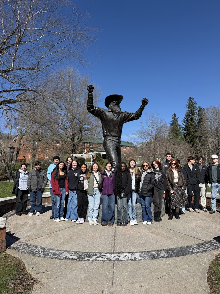 A group of RCS students posing in front a statue at Appalachian State University.