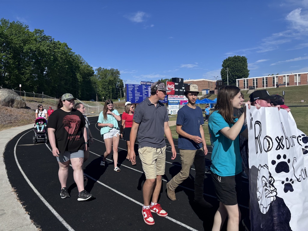 A group of students walking on a track outside