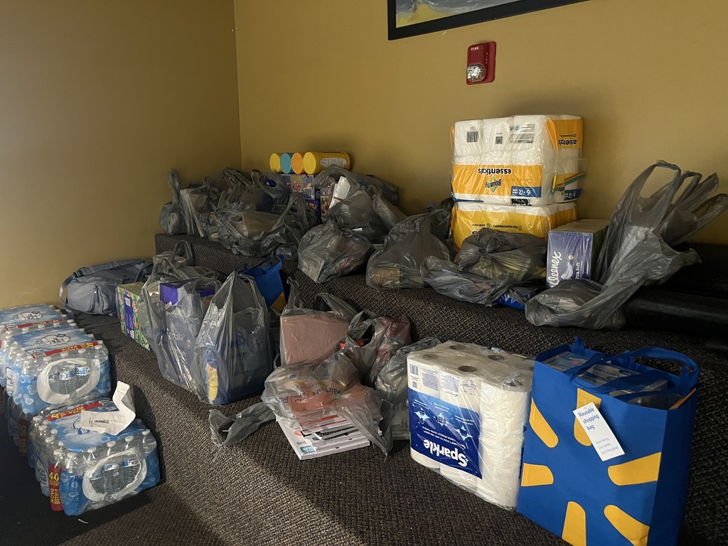 Plastic Walmart bags filled with school supplies in the RCS lobby.