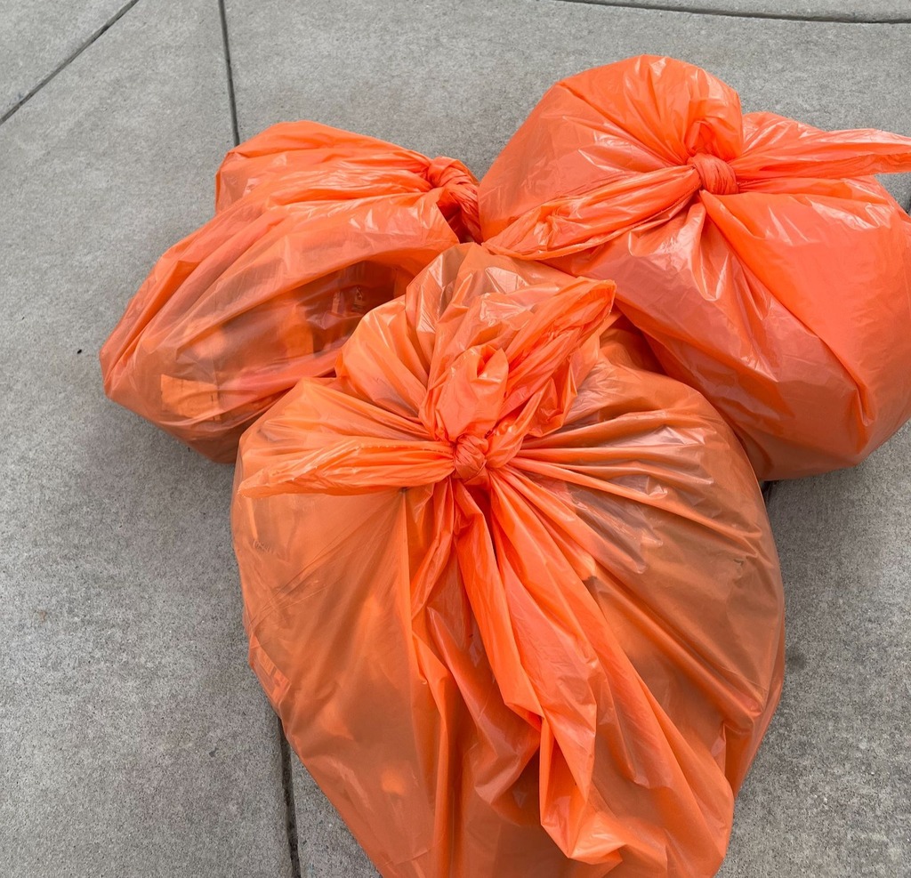 3 orange bags of trash