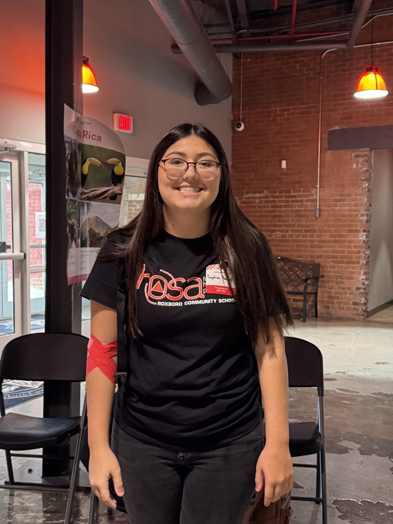 A female student smiling after giving blood