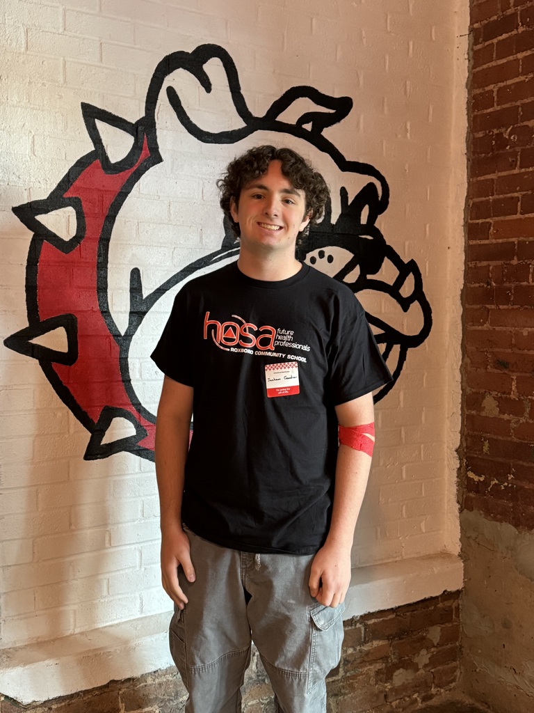 A teenage boy smiling after giving blood
