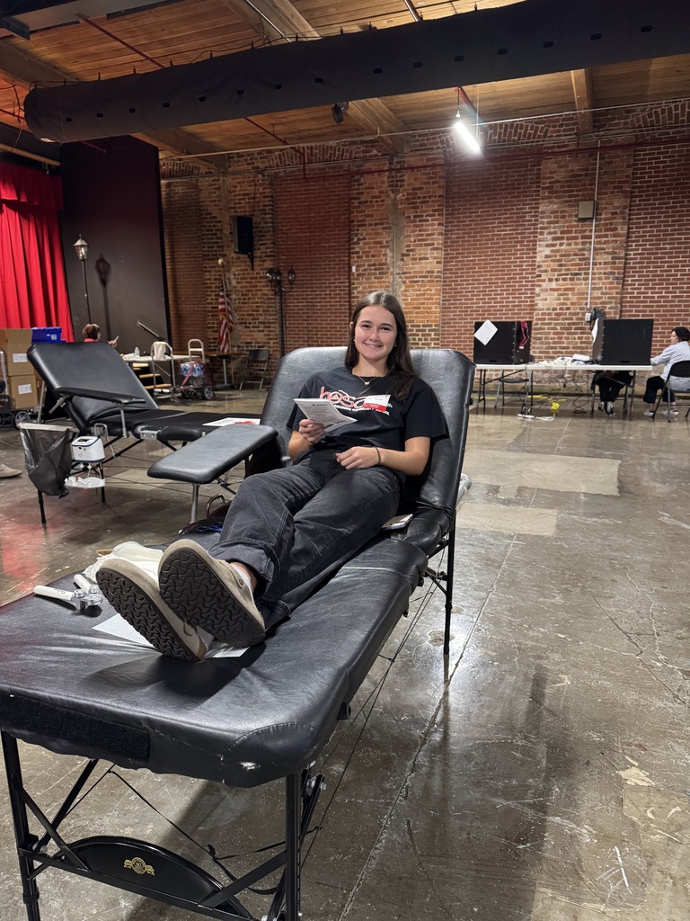 A female student laying on a blood drive chair, preparing to give blood. 