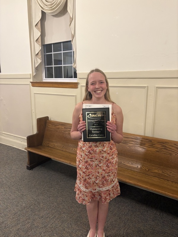 Caroline Cates holding plaque for Roxboro Jaycees Distinguished Service Award for Outstanding Teenager. 
