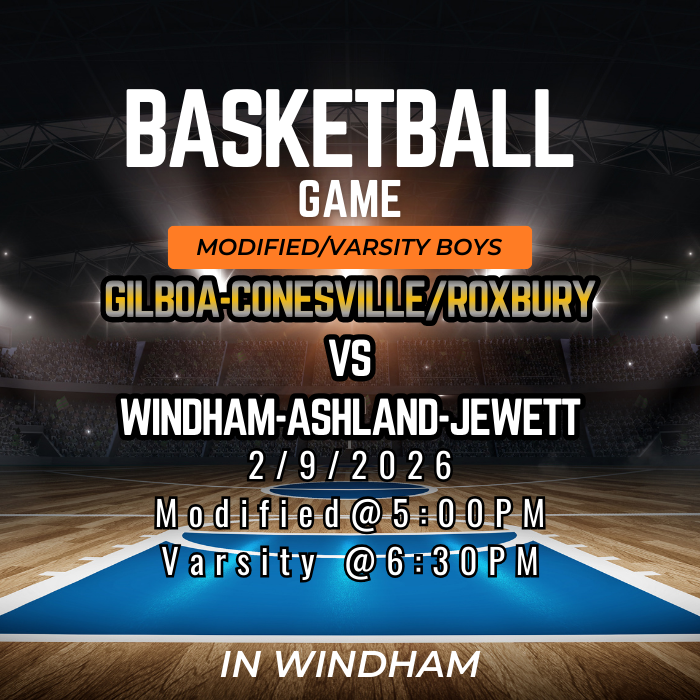 The image is a basketball game announcement graphic. It shows a large indoor basketball arena with bright stadium lights shining over a wooden court. At the top, bold white text reads “Basketball Game,” with an orange banner below that says “Modified/Varsity Boys.” The main text in the center reads “Gilboa–Conesville/Roxbury vs Windham–Ashland–Jewett.” Below that, the date is listed as “2/9/2026.” Further down, the start times are shown: “Modified @ 5:00 PM” and “Varsity @ 6:30 PM.” At the bottom, it says “In Windham.” The overall design uses dark colors with spotlight effects to highlight the court and text.