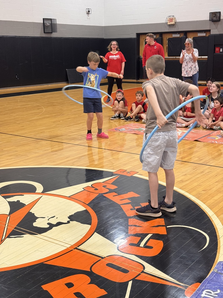 blue team members competing in a hoola hoop contest