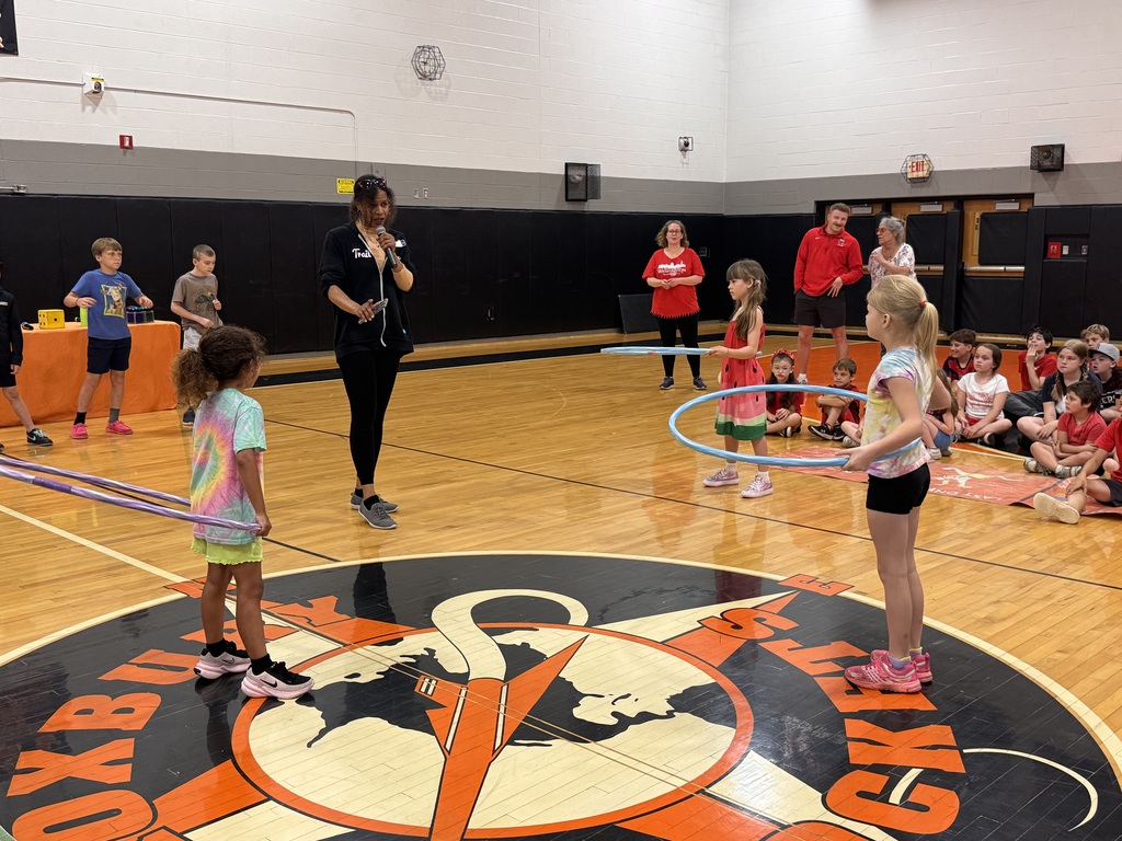 Red team members preparing for a hoola hoop contest