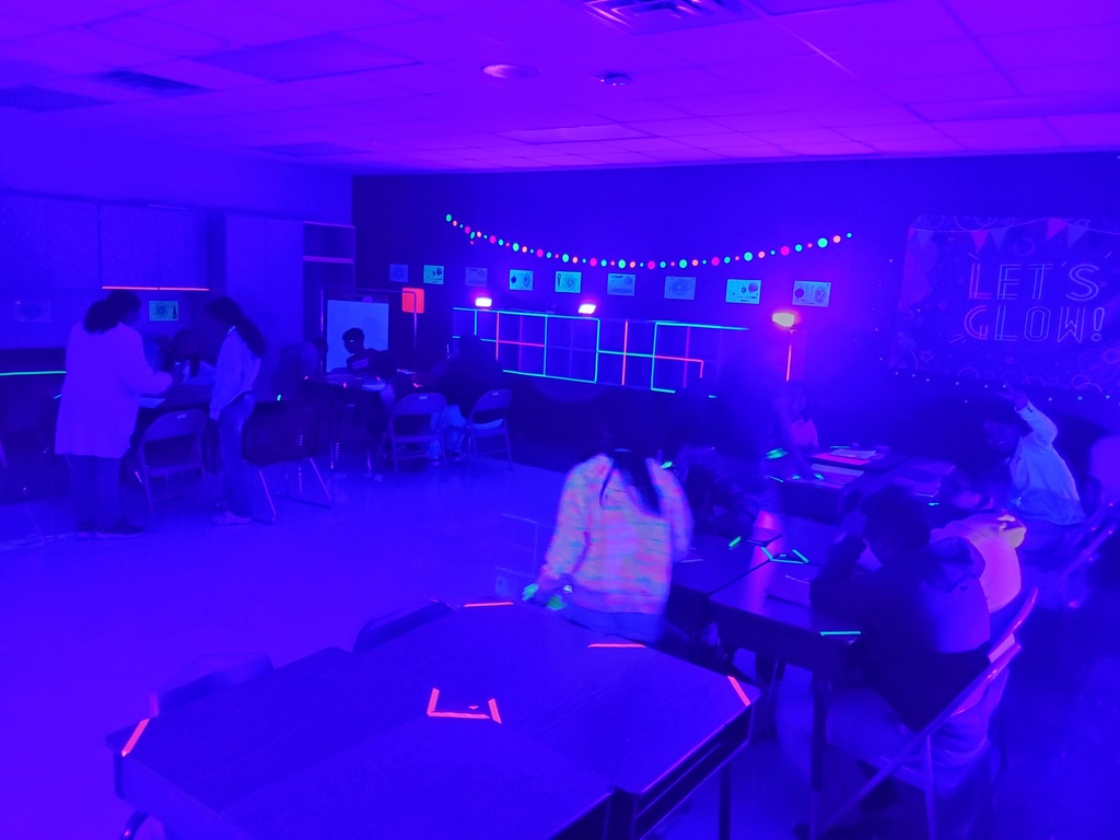 A group of students working in a classroom in their tables.