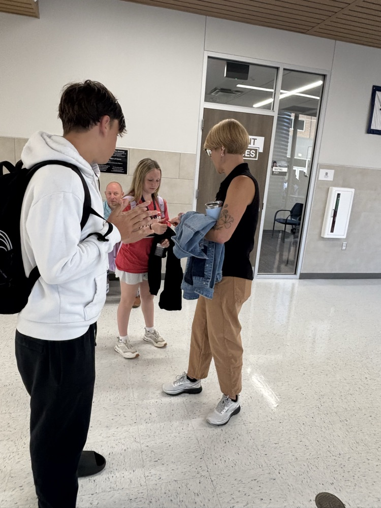 A teacher handing out stickers