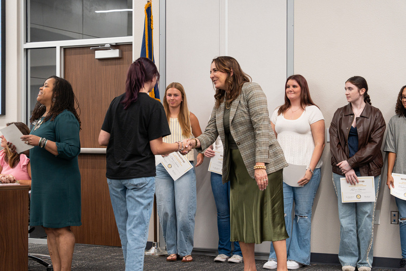 Dr. Anderson shaking a student's hand