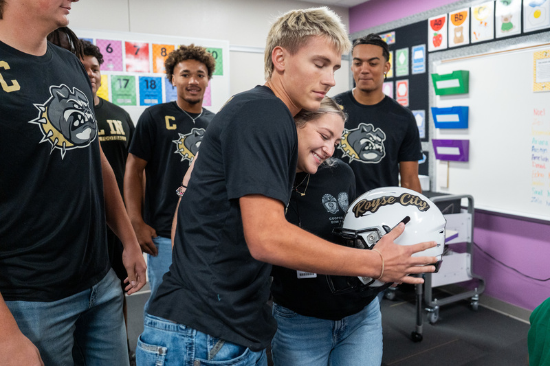 Football presenting Aubrey Dawson with RCHS FB Helmet