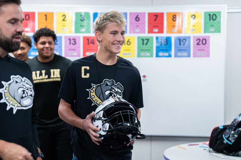 Football presenting Aubrey Dawson with RCHS FB Helmet