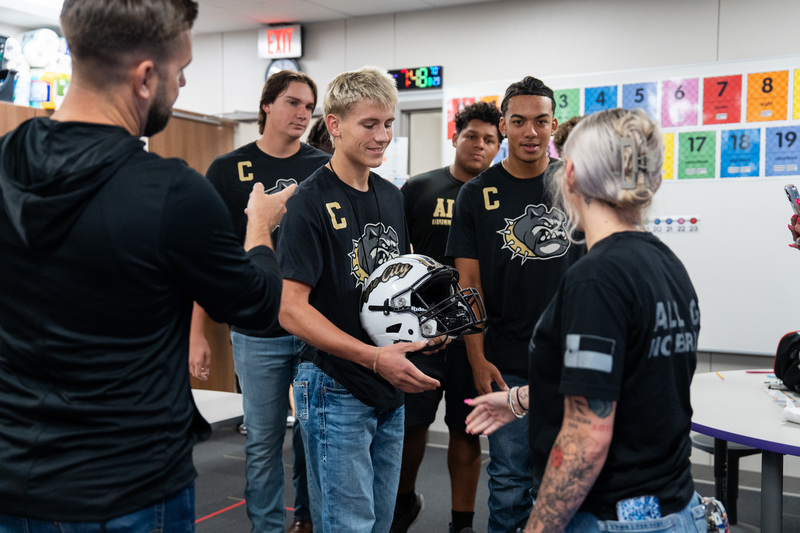 Football presenting Aubrey Dawson with RCHS FB Helmet