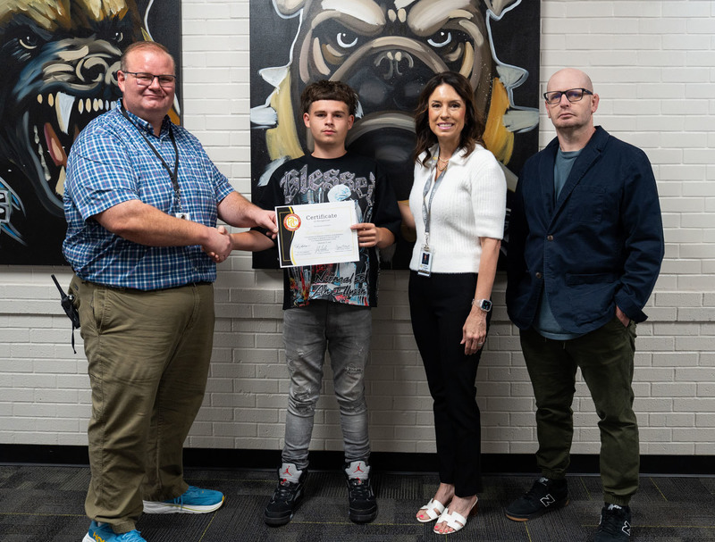 Principal Dr. Jared Smith, Counselor Susan Talbert, and ALC Teacher Justin Strayhorn celebrating with graduate Landyn Pittman.