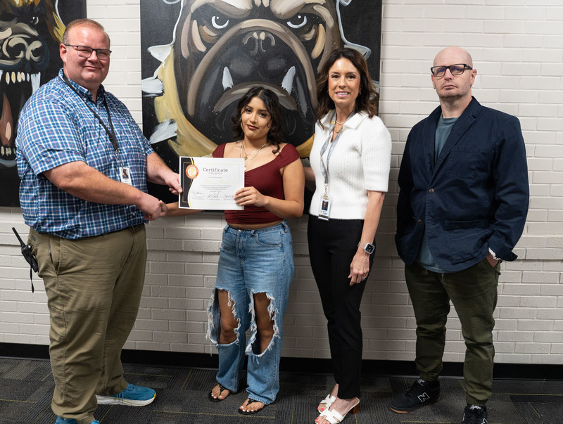 Principal Dr. Jared Smith, Counselor Susan Talbert, and ALC Teacher Justin Strayhorn celebrating with graduate Karen Rosas.