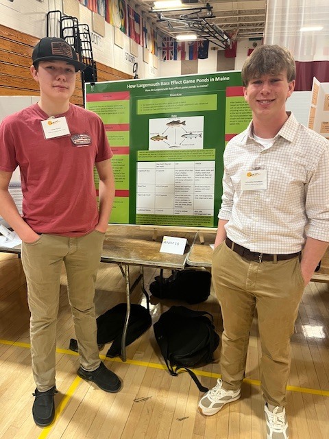 Isaac Furrow and Jack Donaldson pose in front of their projects. 