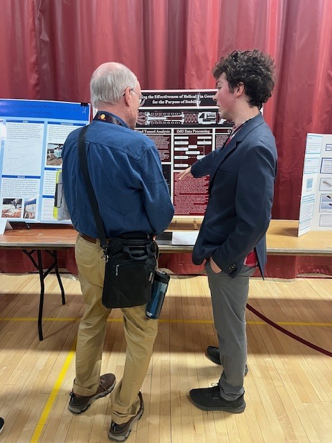 Jeffery Weber presents to a Maine State Science Fair judge. 