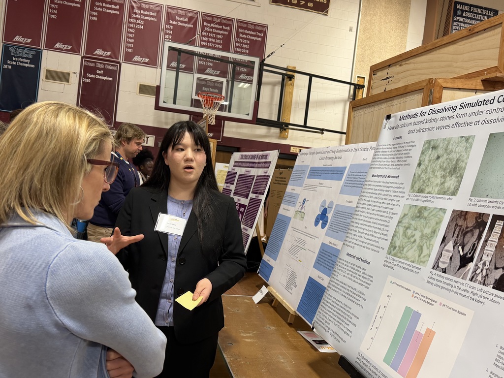 Mizuki Pace presents to a UMaine professor who judged her project. 