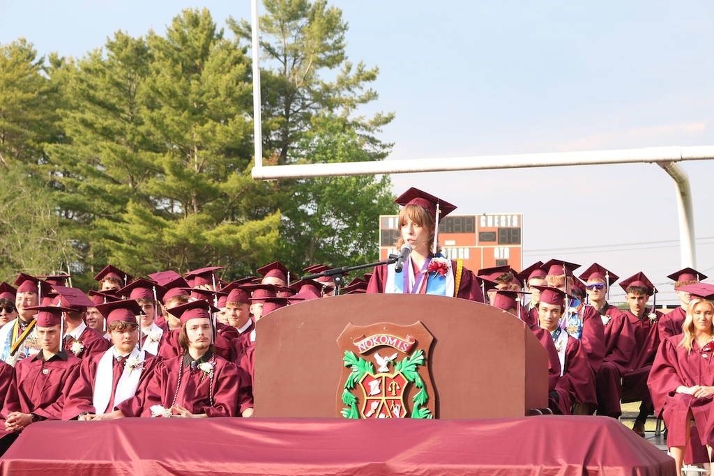 Amber Haining delivers a graduation speech with fellow classmates behind her listening intently. 