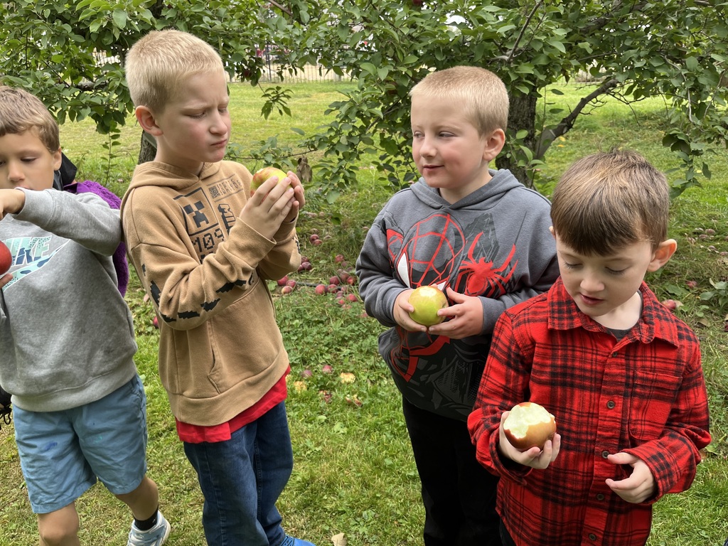 Boys eating apples.