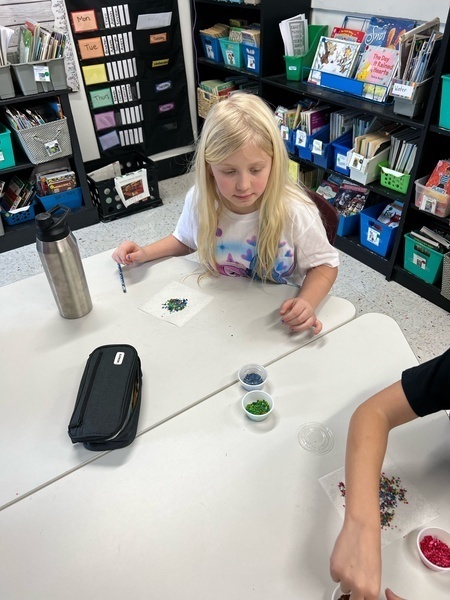 1 girl in white shirt crafting