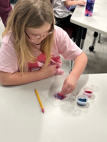 1 girl in pink shirt crafting
