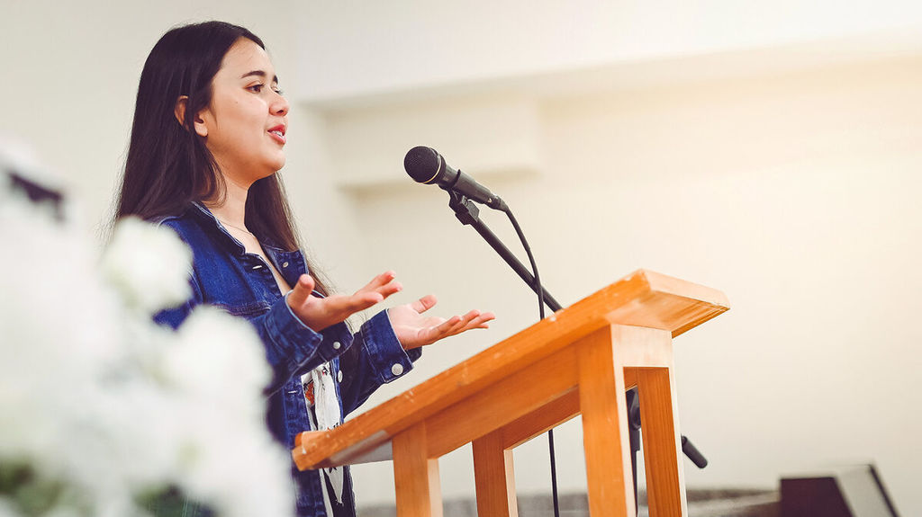 Woman at podium explaining her concern