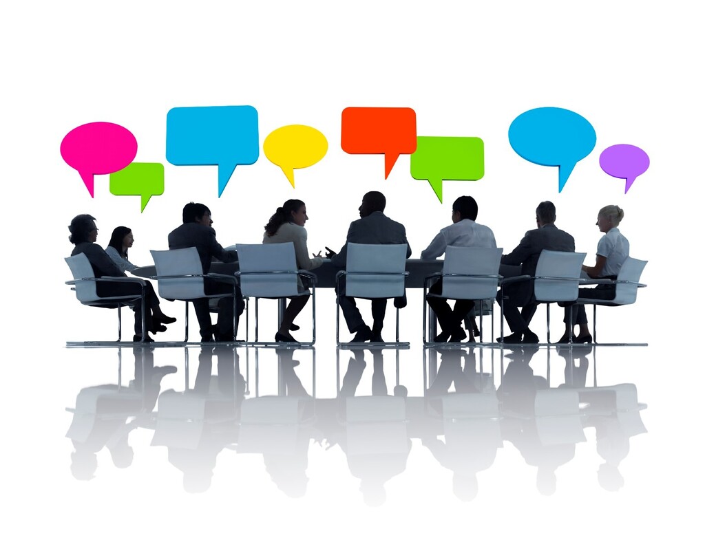 Cartoon of people at a table sharing ideas